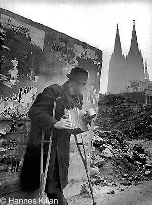 Kriegsheimkehrer mit Krücken und Zieharmonika in Köln,  Copyright Hannes Kilian, Foto 1948 